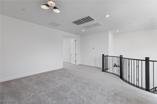 empty room featuring baseboards, carpet, visible vents, and recessed lighting
