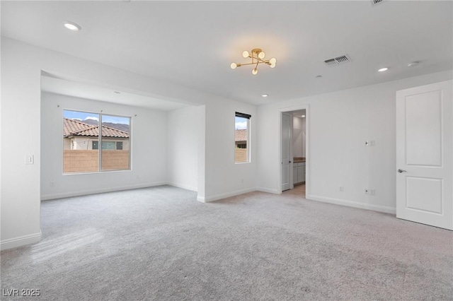empty room with visible vents, baseboards, an inviting chandelier, recessed lighting, and light colored carpet