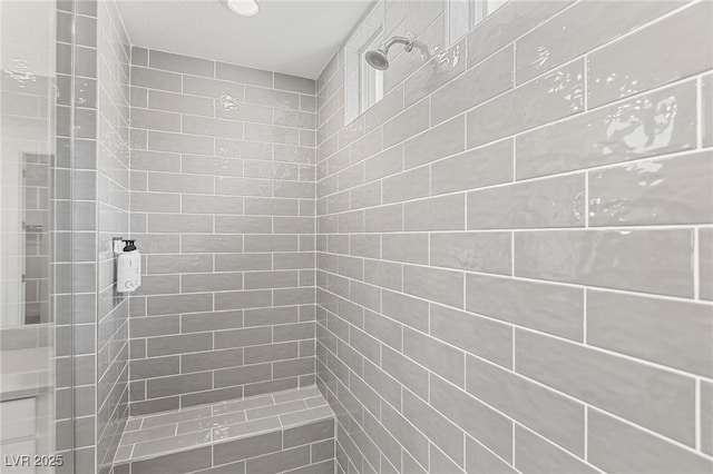 full bath with a tile shower