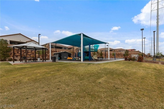 view of property's community with a yard, a gazebo, and playground community