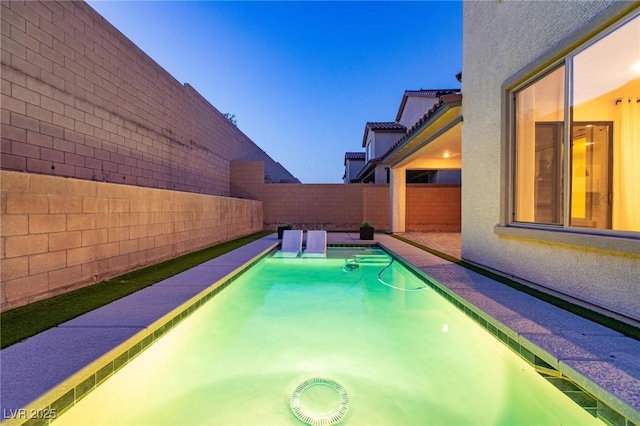 view of pool with a fenced backyard