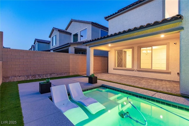 view of pool with a patio and a fenced backyard