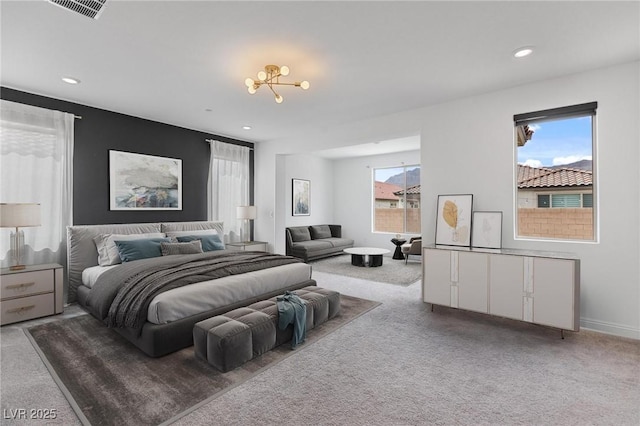 carpeted bedroom with a notable chandelier, visible vents, and recessed lighting
