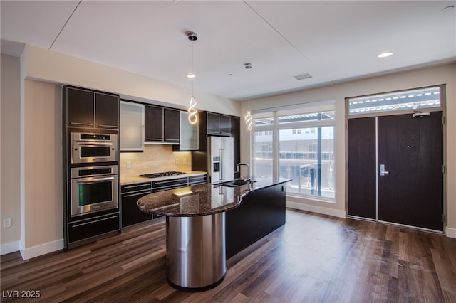 8925 W Flamingo Rd Unit 228, Las Vegas, NV 89147 - kitchen with a warming drawer, stainless steel appliances, backsplash, a sink, and visible vents