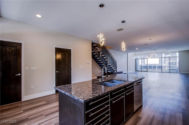 8925 W Flamingo Rd Unit 228, Las Vegas, NV 89147 - kitchen featuring open floor plan, a center island with sink, a sink, and wood finished floors