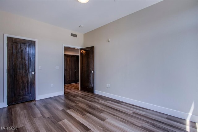8925 W Flamingo Rd Unit 228, Las Vegas, NV 89147 - unfurnished bedroom featuring baseboards, visible vents, and wood finished floors
