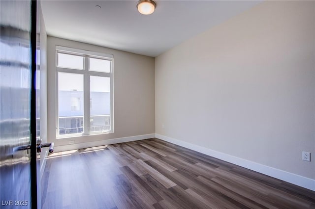 8925 W Flamingo Rd Unit 228, Las Vegas, NV 89147 - spare room featuring baseboards and dark wood-type flooring