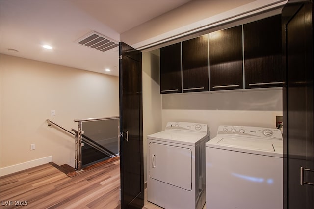 8925 W Flamingo Rd Unit 228, Las Vegas, NV 89147 - laundry room with light wood finished floors, separate washer and dryer, baseboards, visible vents, and cabinet space