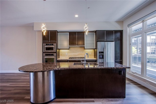 8925 W Flamingo Rd Unit 228, Las Vegas, NV 89147 - kitchen with a sink, backsplash, appliances with stainless steel finishes, and dark wood-style flooring