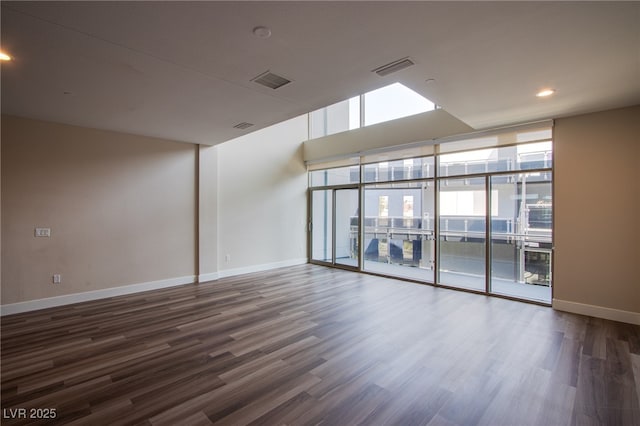 8925 W Flamingo Rd Unit 228, Las Vegas, NV 89147 - unfurnished room with baseboards, visible vents, and dark wood-type flooring