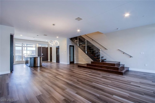 8925 W Flamingo Rd Unit 228, Las Vegas, NV 89147 - unfurnished living room featuring stairs, recessed lighting, baseboards, dark wood-style floors, and visible vents
