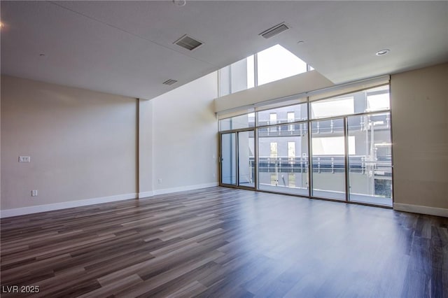 8925 W Flamingo Rd Unit 228, Las Vegas, NV 89147 - unfurnished room with baseboards, visible vents, and wood finished floors