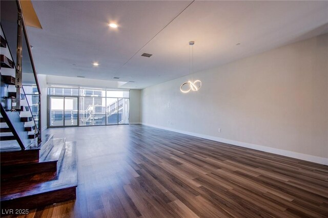 8925 W Flamingo Rd Unit 228, Las Vegas, NV 89147 - unfurnished living room featuring stairway, baseboards, visible vents, recessed lighting, and dark wood-style flooring