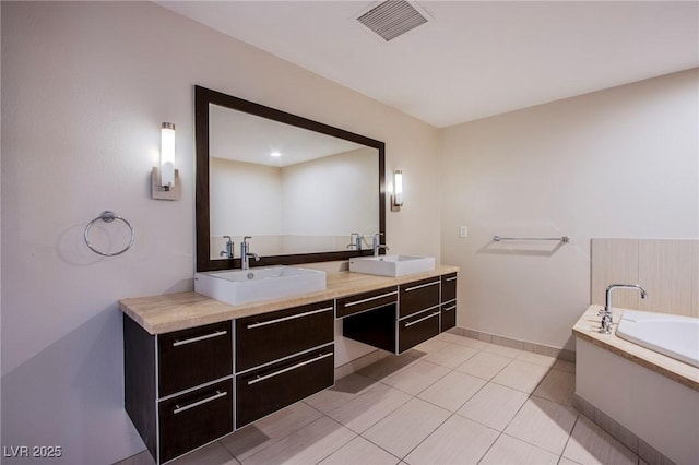 8925 W Flamingo Rd Unit 228, Las Vegas, NV 89147 - full bath with visible vents, a sink, a garden tub, and double vanity