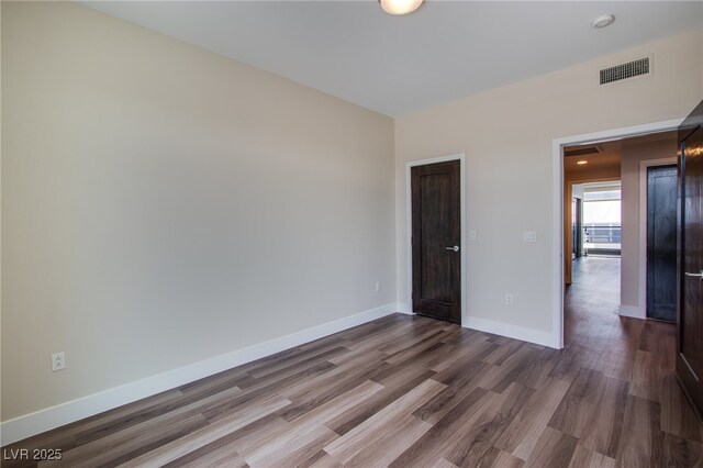 8925 W Flamingo Rd Unit 228, Las Vegas, NV 89147 - unfurnished bedroom featuring baseboards, visible vents, and wood finished floors