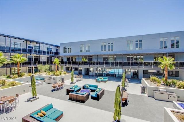 8925 W Flamingo Rd Unit 228, Las Vegas, NV 89147 - surrounding community featuring a patio and an outdoor living space with a fire pit