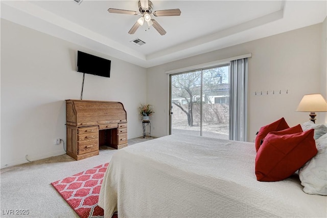 bedroom featuring a tray ceiling, visible vents, light carpet, access to exterior, and baseboards