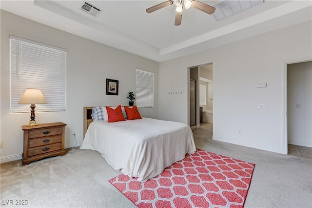 bedroom with a raised ceiling, light carpet, baseboards, and visible vents