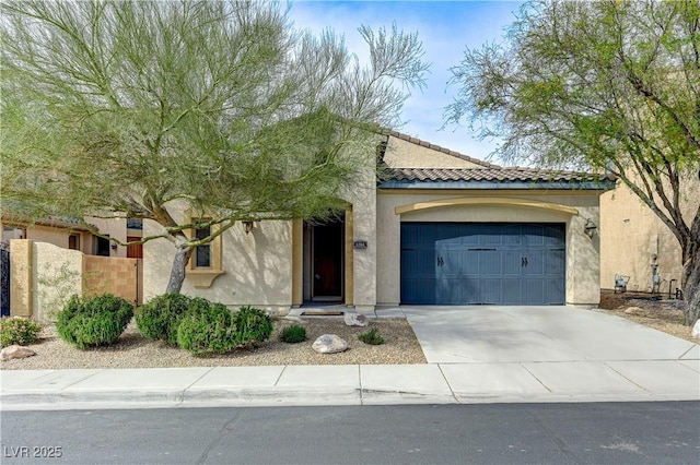 view of front of house featuring an attached garage, concrete driveway, stucco siding, and a tile roof