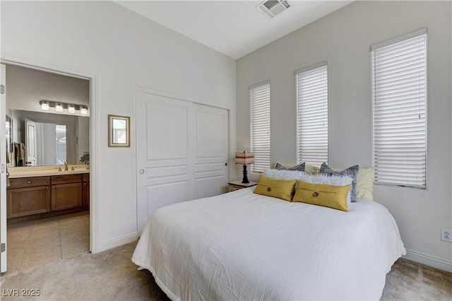bedroom featuring visible vents, baseboards, multiple windows, and light carpet