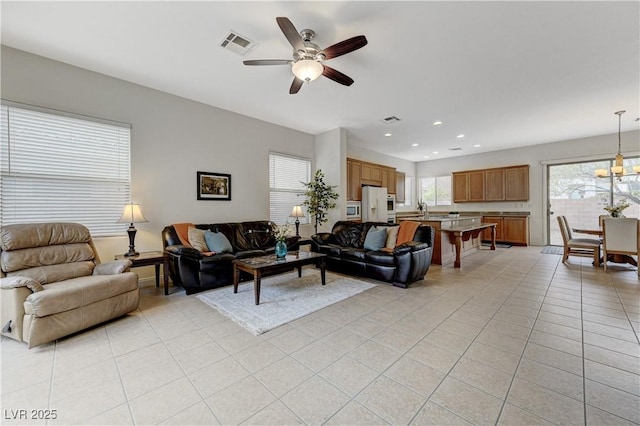 living room with recessed lighting, visible vents, a ceiling fan, and light tile patterned flooring