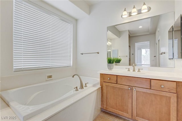 bathroom featuring tile patterned floors, vanity, and a garden tub