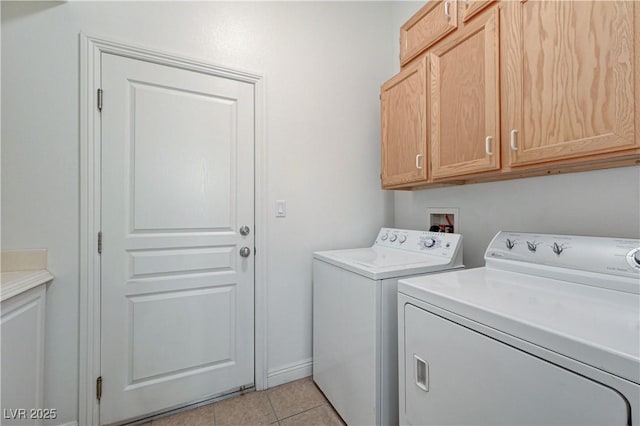 laundry room featuring washer and dryer, light tile patterned floors, baseboards, and cabinet space