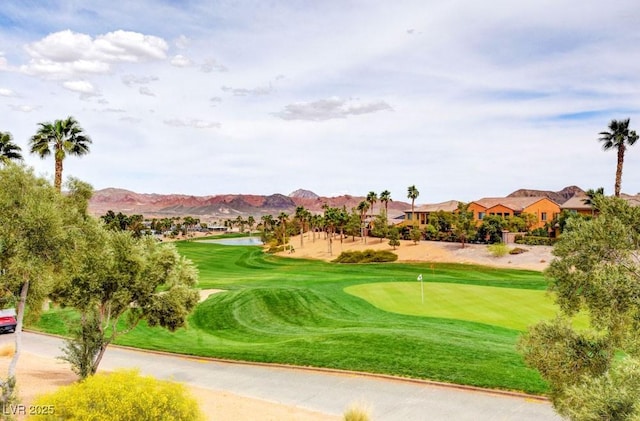 view of property's community with a mountain view and view of golf course
