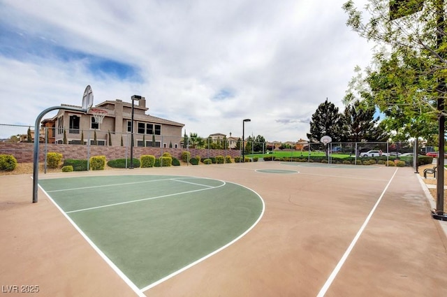 view of basketball court with community basketball court and fence