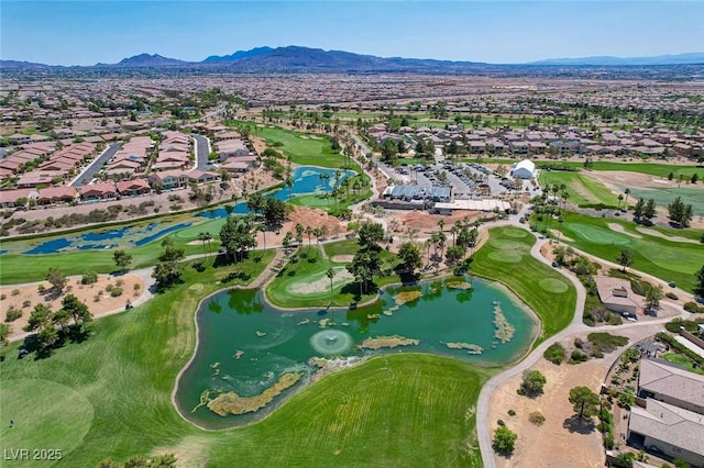 birds eye view of property with golf course view, a water and mountain view, and a residential view