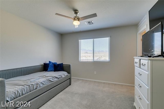 carpeted bedroom with baseboards, visible vents, and a ceiling fan