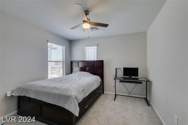 bedroom with baseboards, ceiling fan, visible vents, and light carpet