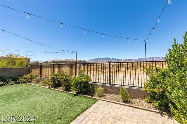 view of yard with a fenced backyard and a mountain view