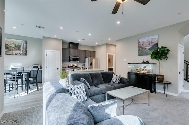 living area featuring a ceiling fan, recessed lighting, and visible vents