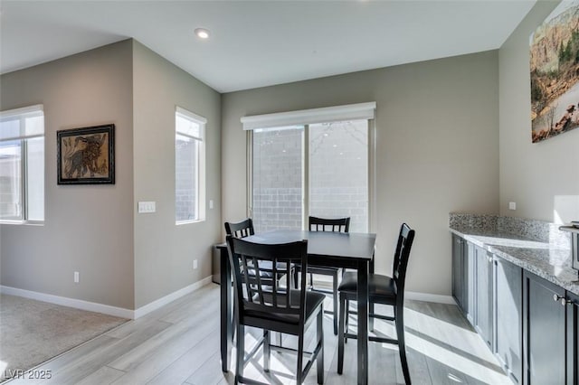 dining room featuring recessed lighting, baseboards, and light wood-type flooring