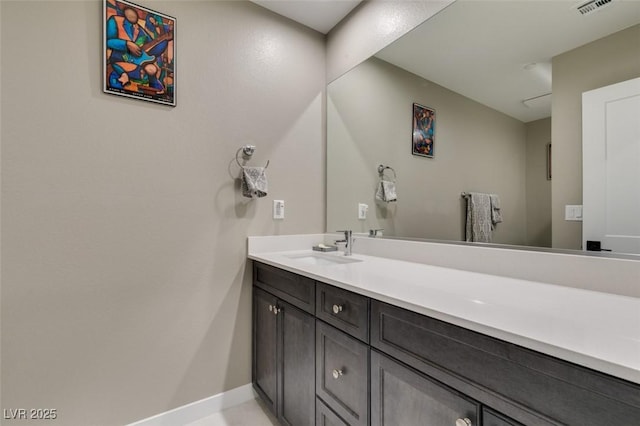 bathroom featuring vanity, baseboards, and visible vents