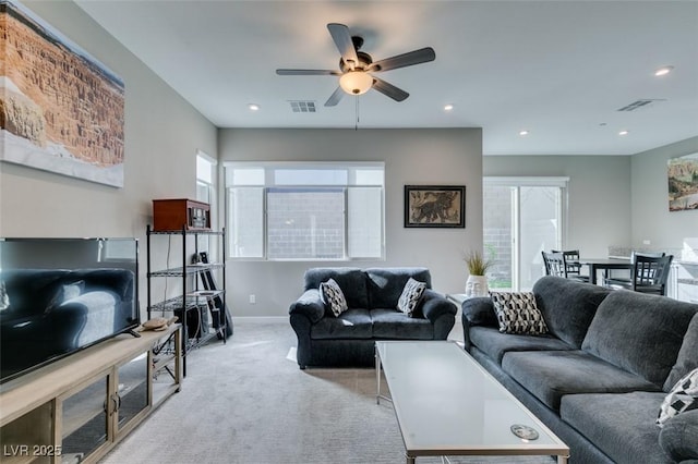 carpeted living area featuring a ceiling fan, recessed lighting, and visible vents