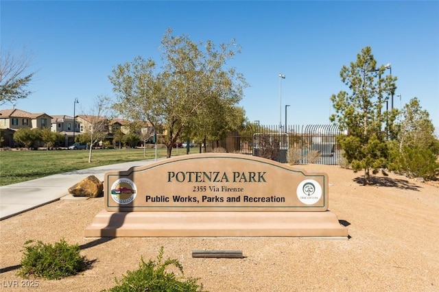 community / neighborhood sign with a residential view