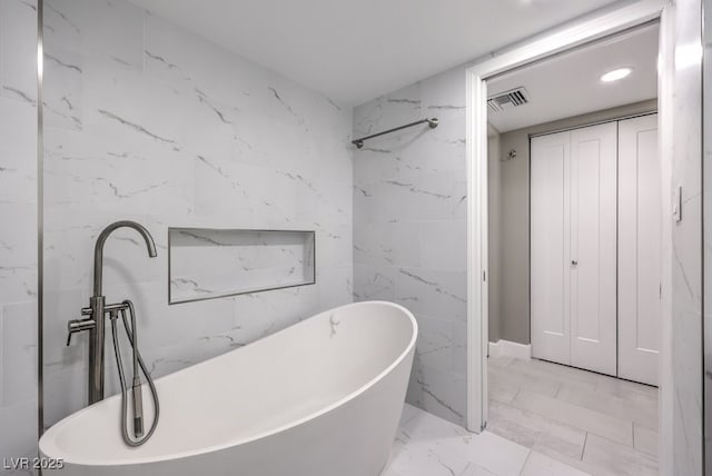 205 E Harmon Ave Unit 1007, Las Vegas, NV 89169 - full bathroom featuring a freestanding bath, marble finish floors, and recessed lighting