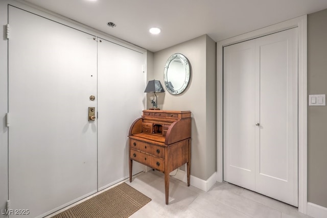 entrance foyer featuring baseboards, recessed lighting, and light tile patterned floors