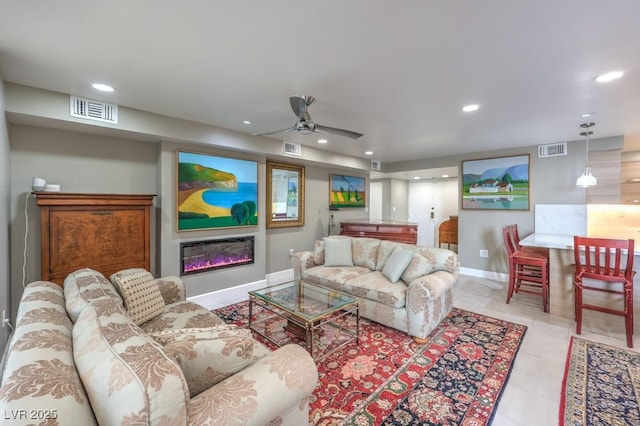 living room with recessed lighting, visible vents, and baseboards