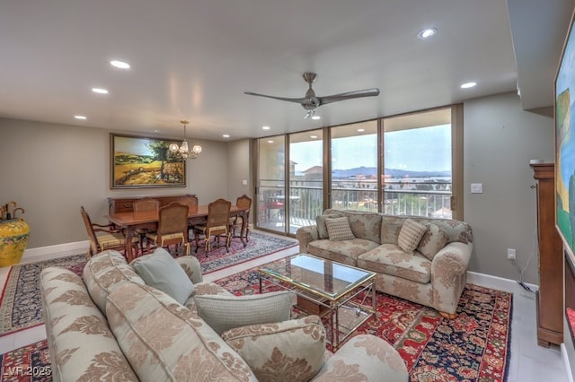 living room with recessed lighting, floor to ceiling windows, baseboards, and ceiling fan with notable chandelier