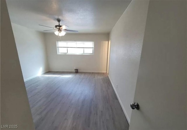 3749 Ponderosa Ave, Las Vegas, NV 89115 - spare room featuring baseboards, a textured ceiling, wood finished floors, and a ceiling fan