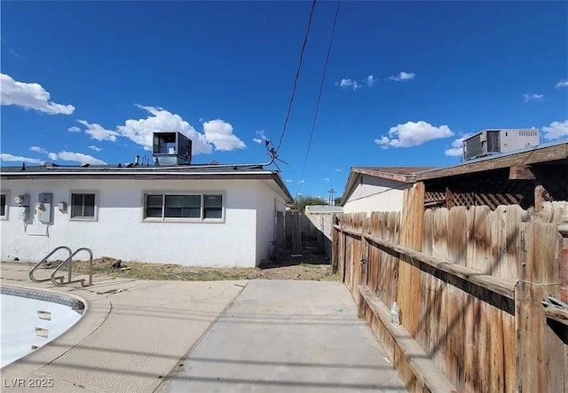 3749 Ponderosa Ave, Las Vegas, NV 89115 - view of side of property featuring central AC unit, stucco siding, fence, and a patio area