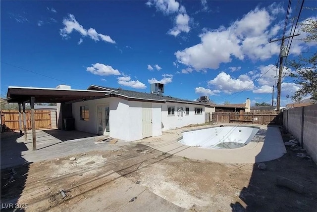 3749 Ponderosa Ave, Las Vegas, NV 89115 - rear view of property featuring stucco siding, a fenced backyard, and a patio