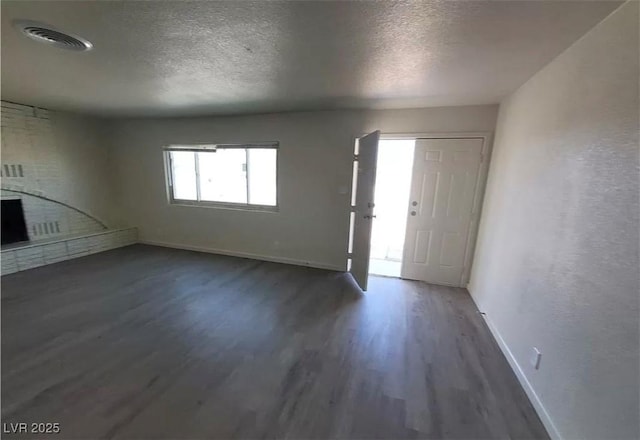 3749 Ponderosa Ave, Las Vegas, NV 89115 - entrance foyer with baseboards, a textured ceiling, visible vents, and wood finished floors