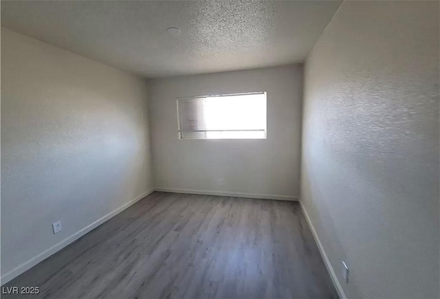 3749 Ponderosa Ave, Las Vegas, NV 89115 - unfurnished room featuring baseboards, a textured ceiling, and wood finished floors