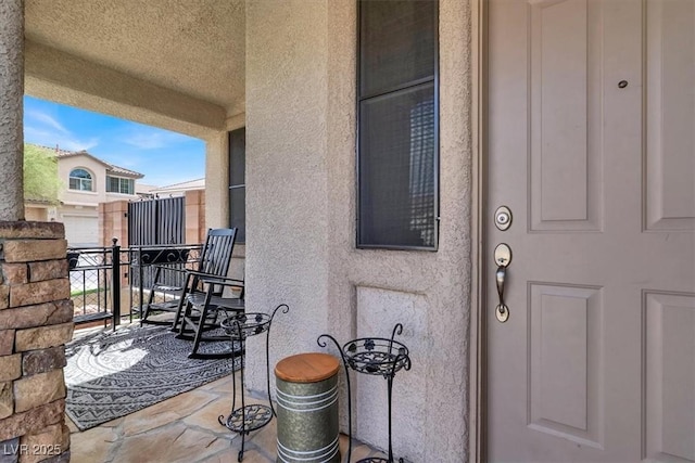 entrance to property with stucco siding