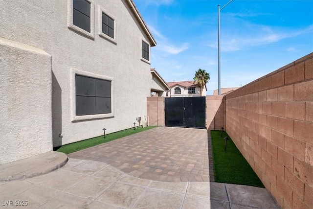 exterior space featuring a patio, a fenced backyard, and stucco siding
