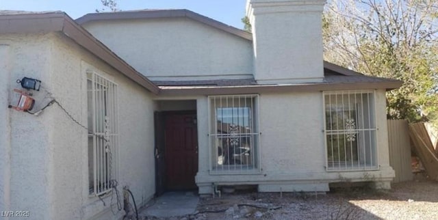 3711 Southern Light Dr, Las Vegas, NV 89115 - exterior space featuring a chimney and stucco siding
